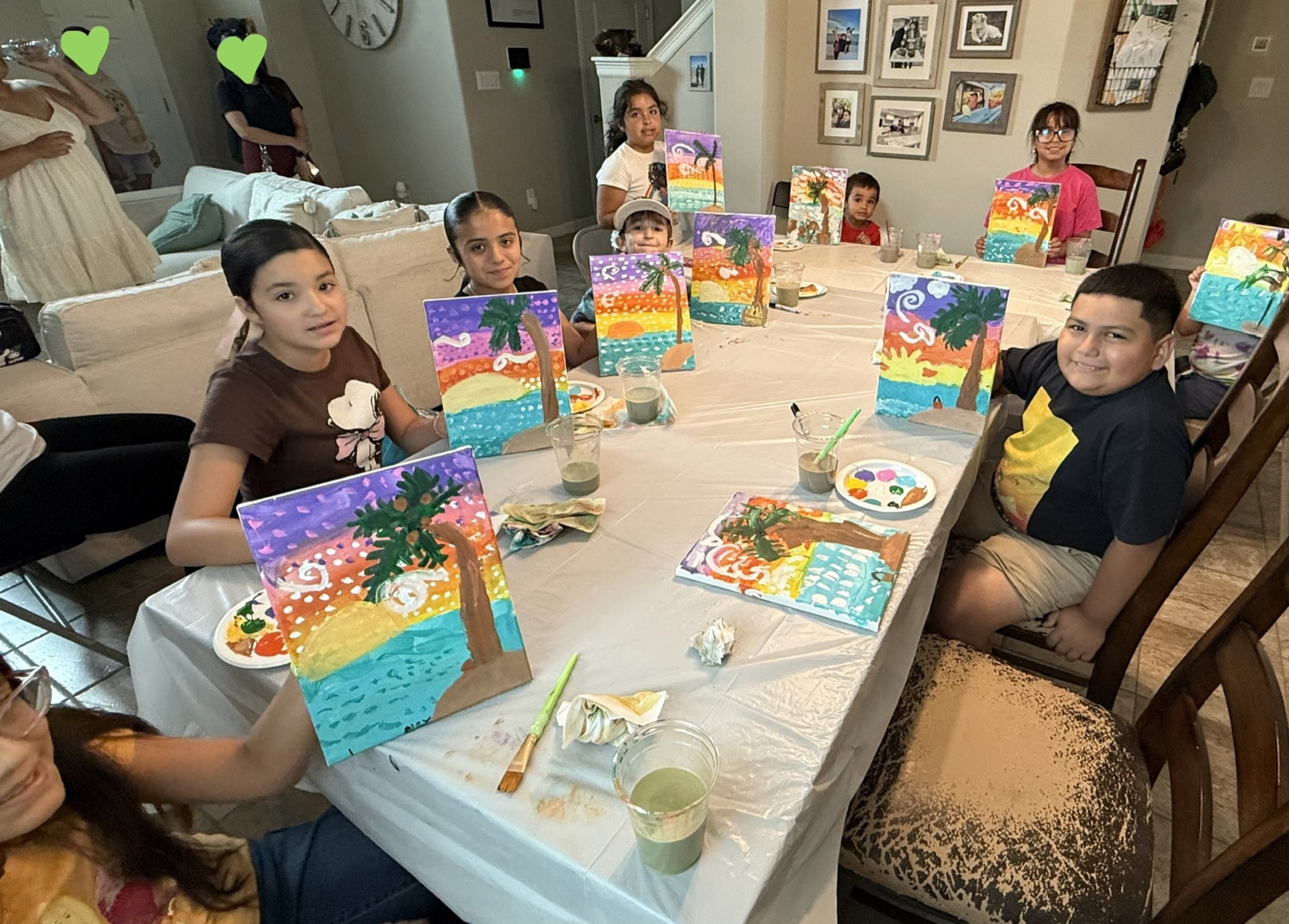 Creative Corner students proudly sharing their colorful sunset paintings